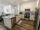 Apartment kitchen furnished with stainless steel appliances
